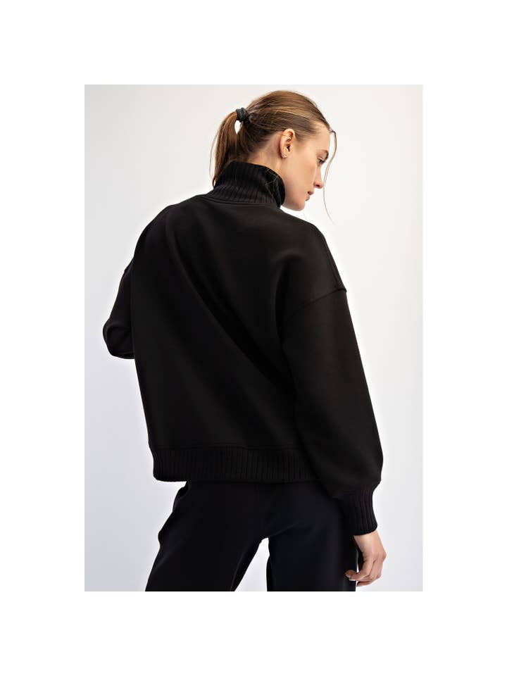 black pull over sweater with turtleneck