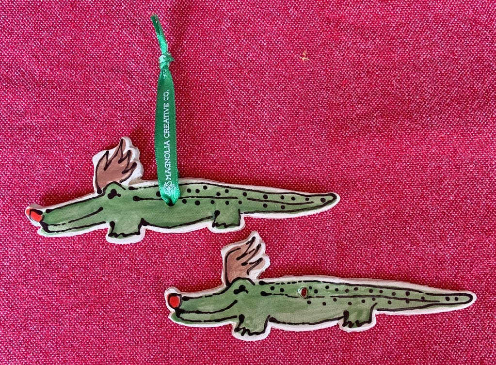 Magnolia Creative Co Alligator Reindeer ornament hanging on a tree