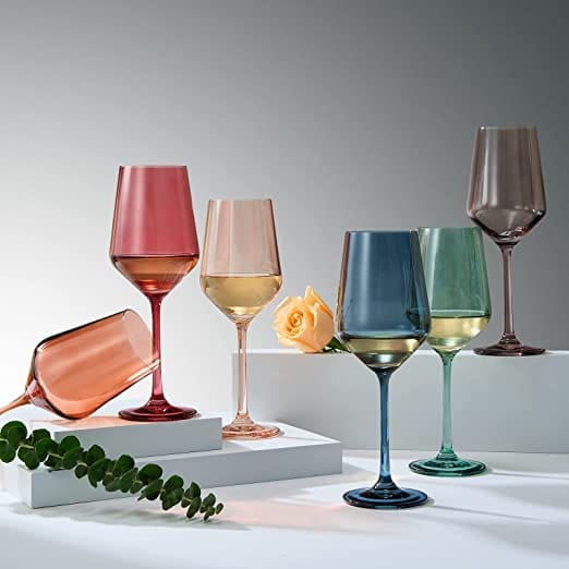Muted red, blue, tan, grey, green and orange stemmed wine glasses