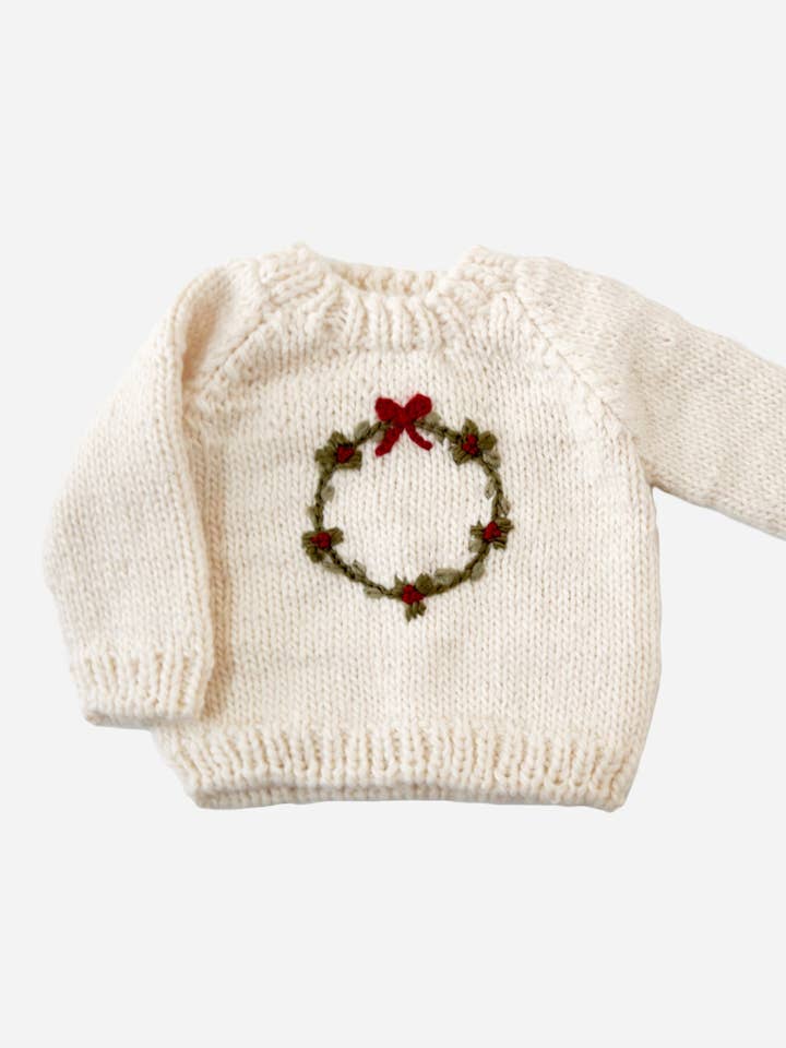 little girls cream sweater with christmas wreath