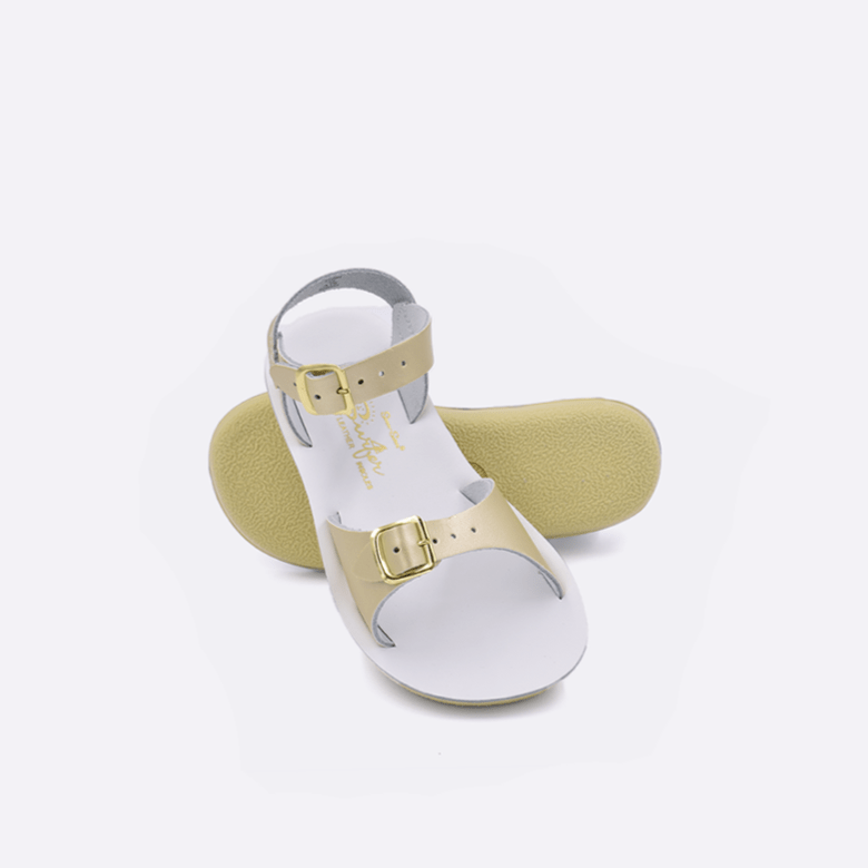 Double strap, rubber sole, leather surfer sandal by Saltwater Sandals in gold for children sizes five through twelve.