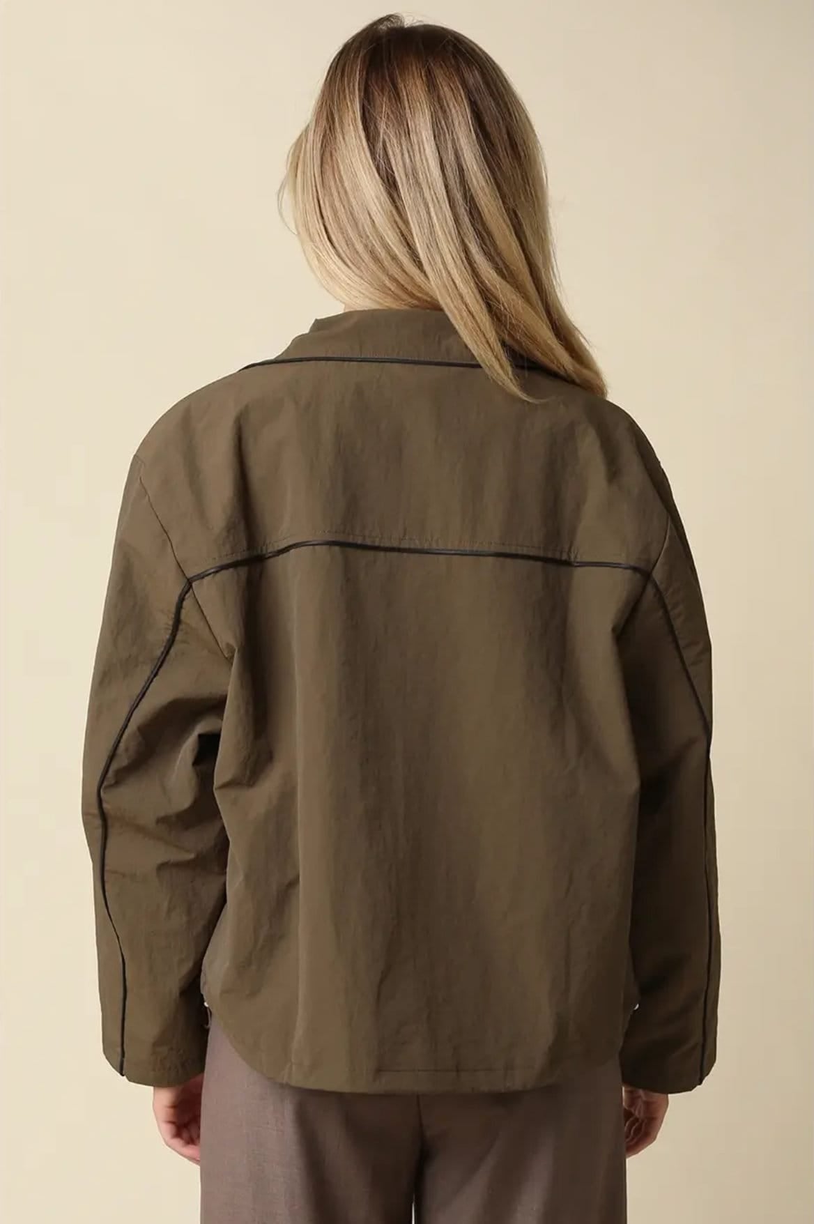 Back of Alina olive jacket with black piped yoke and curved hem