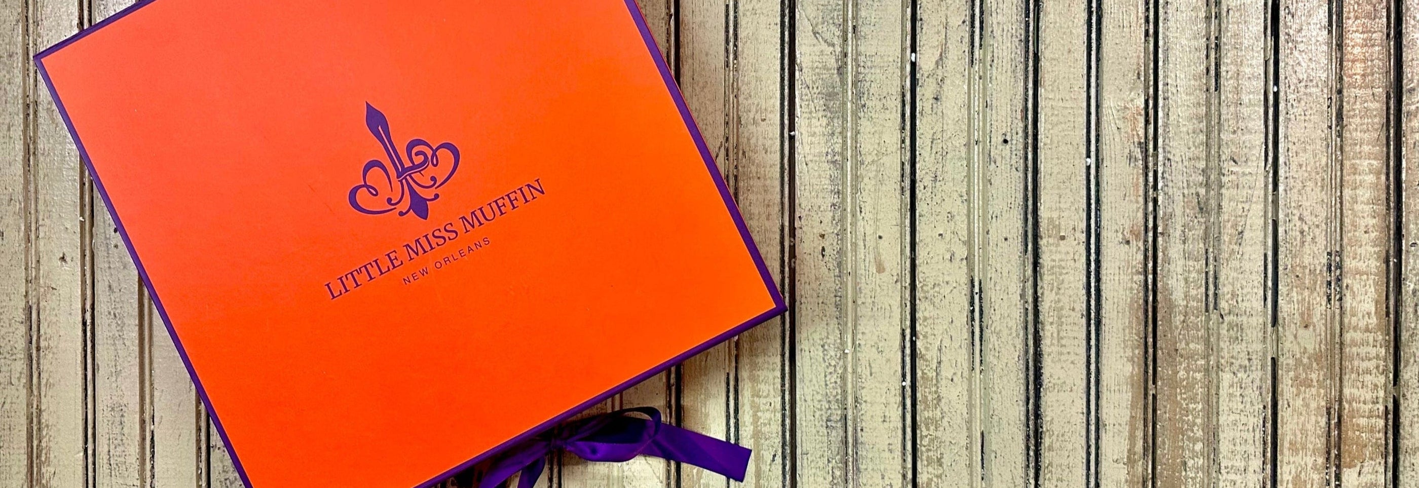 Orange box with a logo on a wooden surface
